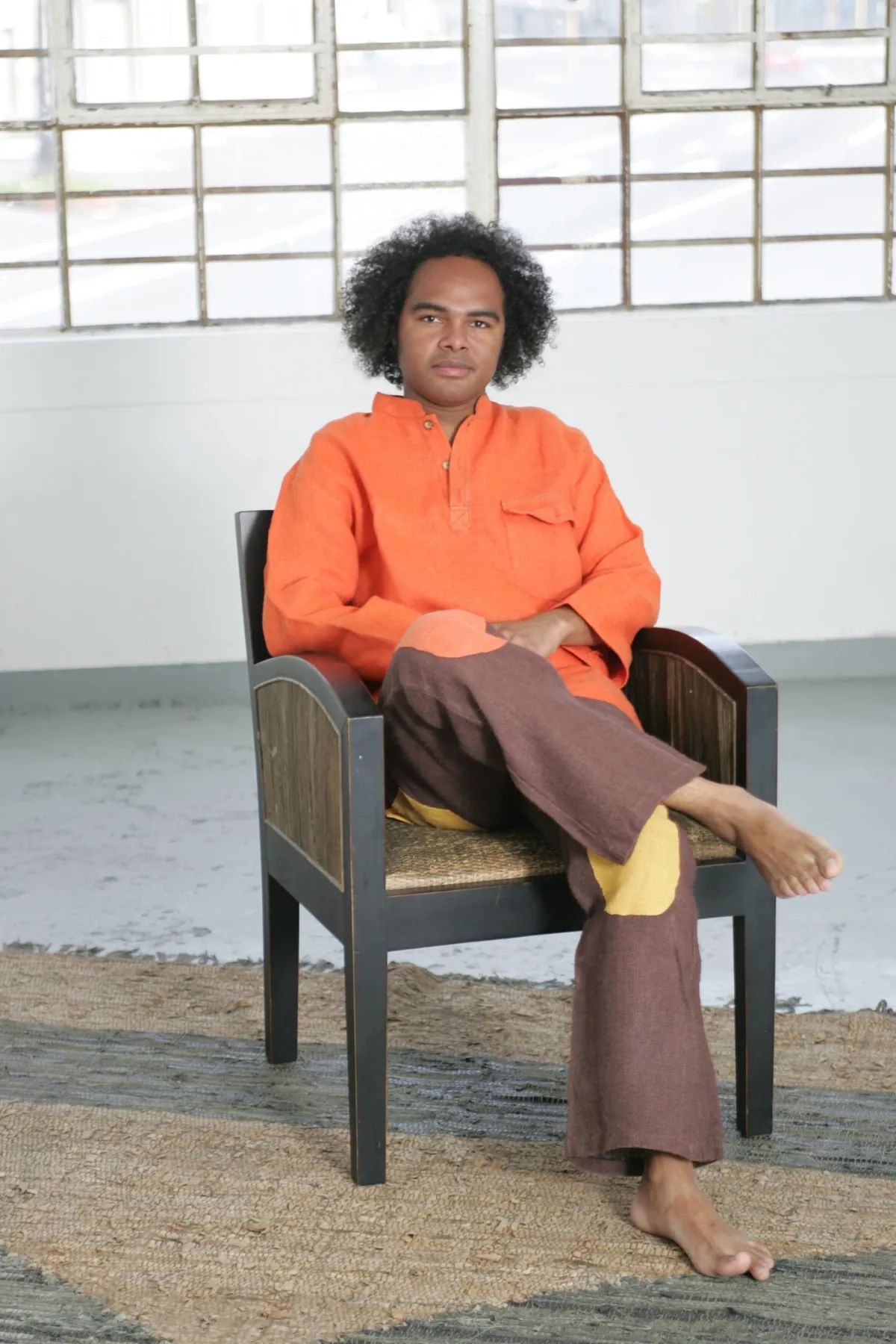 Dino Miranda. Seated portrait, orange shirt